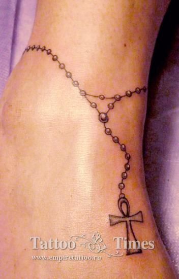 Татуировка крестика на ноге